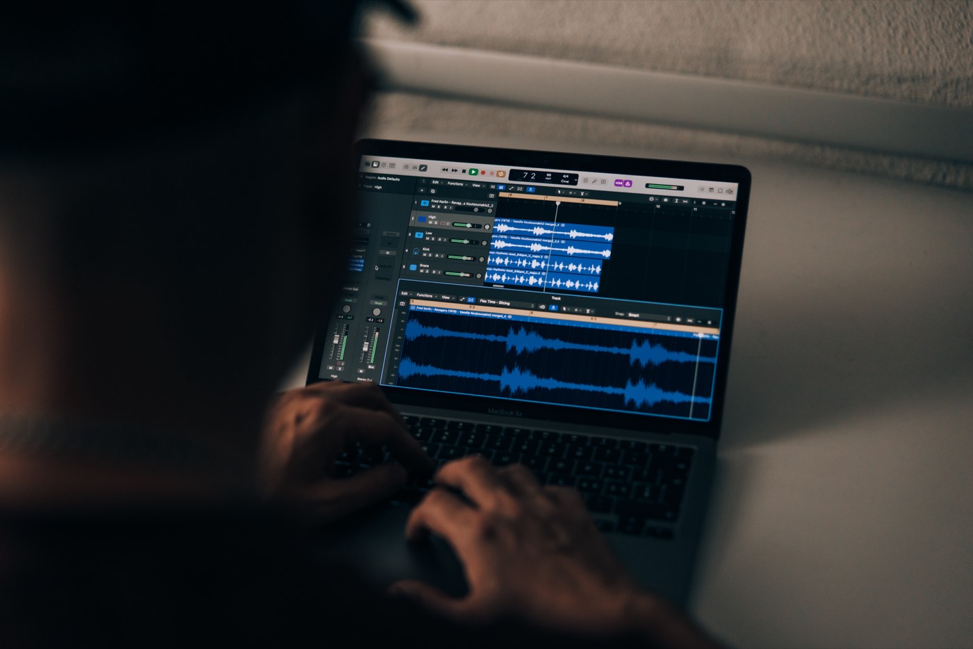 Vaynex at the laptop with Logic Pro, waveforms visible